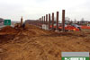 4/11/11: Progress on the sound wall on the southbound outer roadway. The sound wall panels slip in between the posts that are installed here.