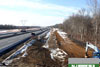 1/5/11: A progress photo of work on the future North to South Outer Roadway (NSO) near Perrineville Road/County Road 630. Barriers and temporary signs have been placed to protect traffic and the worksite, and earthwork has begun.