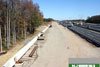 October 2011: a view of the north to south outer roadway (NSO) looking north from the Windsor Road bridge. A retention wall (left) has been installed and the roadbed fill has been graded prior to paving.