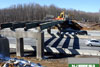 February 2011: Another view of the Windsor Road bridge during demolition. To remove the concrete from the steel beams of the bridge, the concrete must be broken. This work is usually done at low volume traffic times at night. Shielding is installed to prevent concrete and other debris from falling onto the open NJ Turnpike below. Once the concrete is removed, the steel beams will be taken down and the piers will then be demolished.