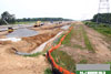 June 2011: A view looking north at the construction progress for the northbound outer roadway (SNO). Retaining wall footings for the new outer roadway are in process of being installed.