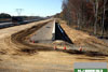October 2011: A newly installed retention wall on the southbound outer roadway near Perrineville Road.