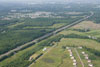 June 2009: A preconstruction view of part of the Contract 503 project area from the East side of the NJ Turnpike looking northwest. Perrineville Road is located in the approximate center of the photograph.